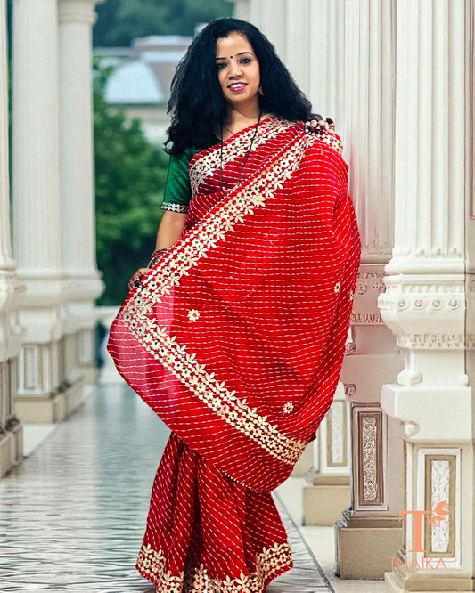 Elegant red Kota Doria Gotta Patti saree with shimmering golden accents and delicate craftsmanship.