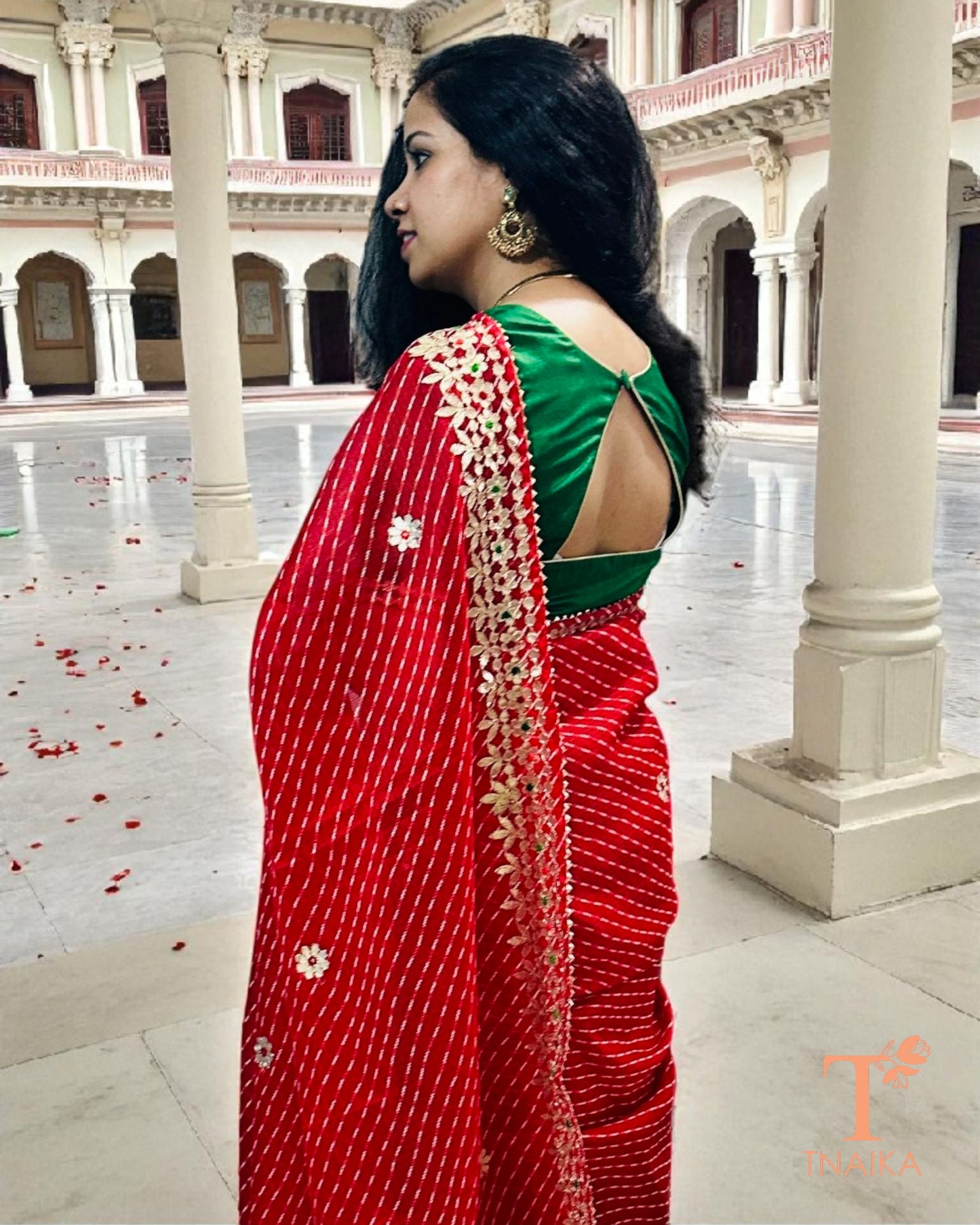 Festive red Kota Doria saree featuring rich Gotta Patti embroidery, perfect for weddings and celebrations.