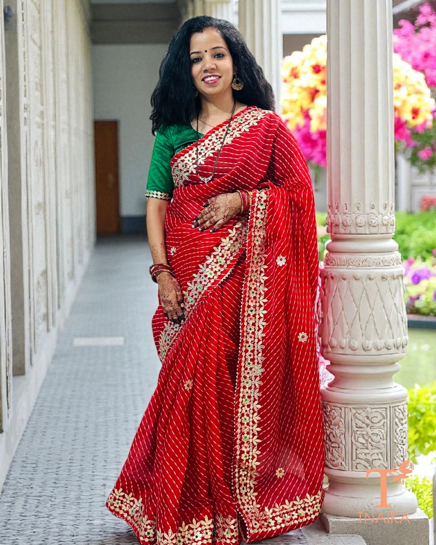 Red Kota Doria saree adorned with traditional Gotta Patti work and intricate hand detailing.