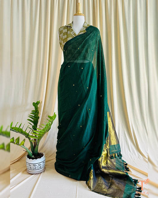 Mannequin wearing green cotton regal saree with foil tikki design and golden tissue pallu for festive occasions