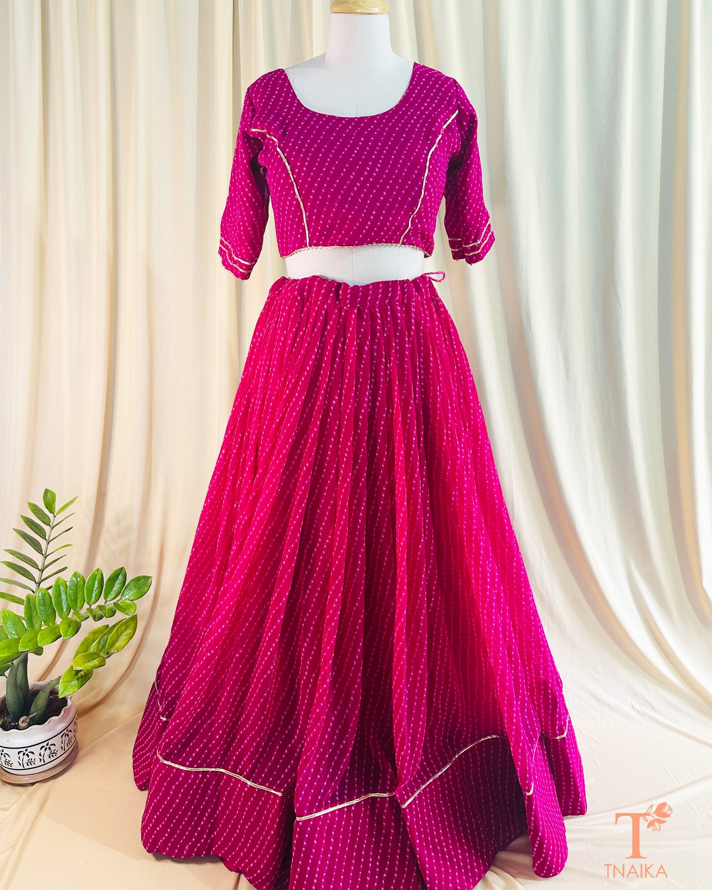 Vibrant Leheriya georgette lehenga featuring lace detailing, ideal for weddings and festive occasions