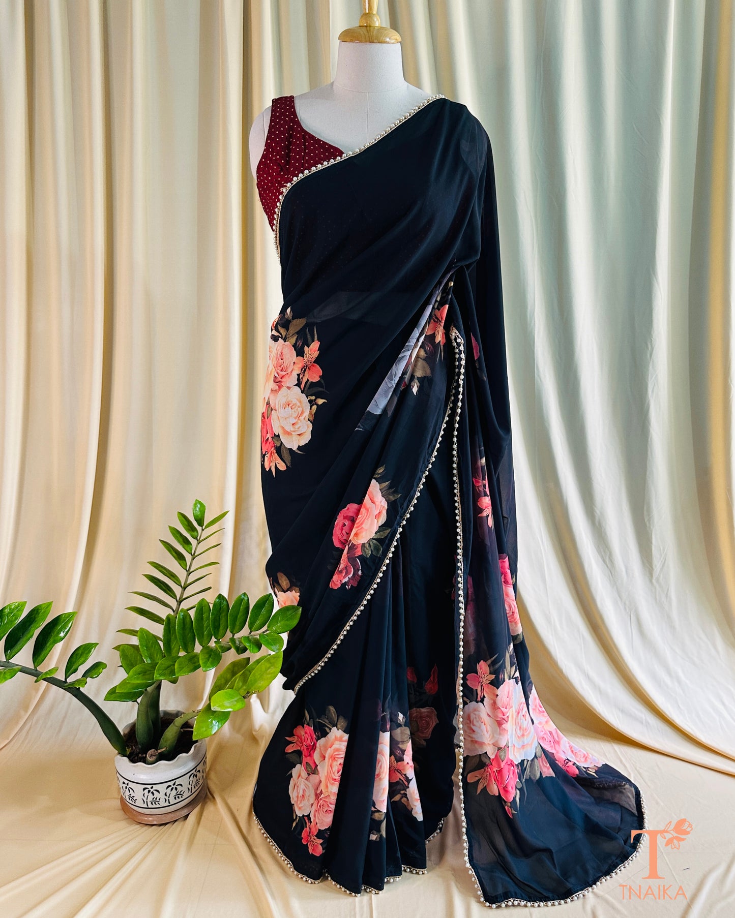 Lightweight floral georgette saree featuring pearl lace detailing for festive wear.