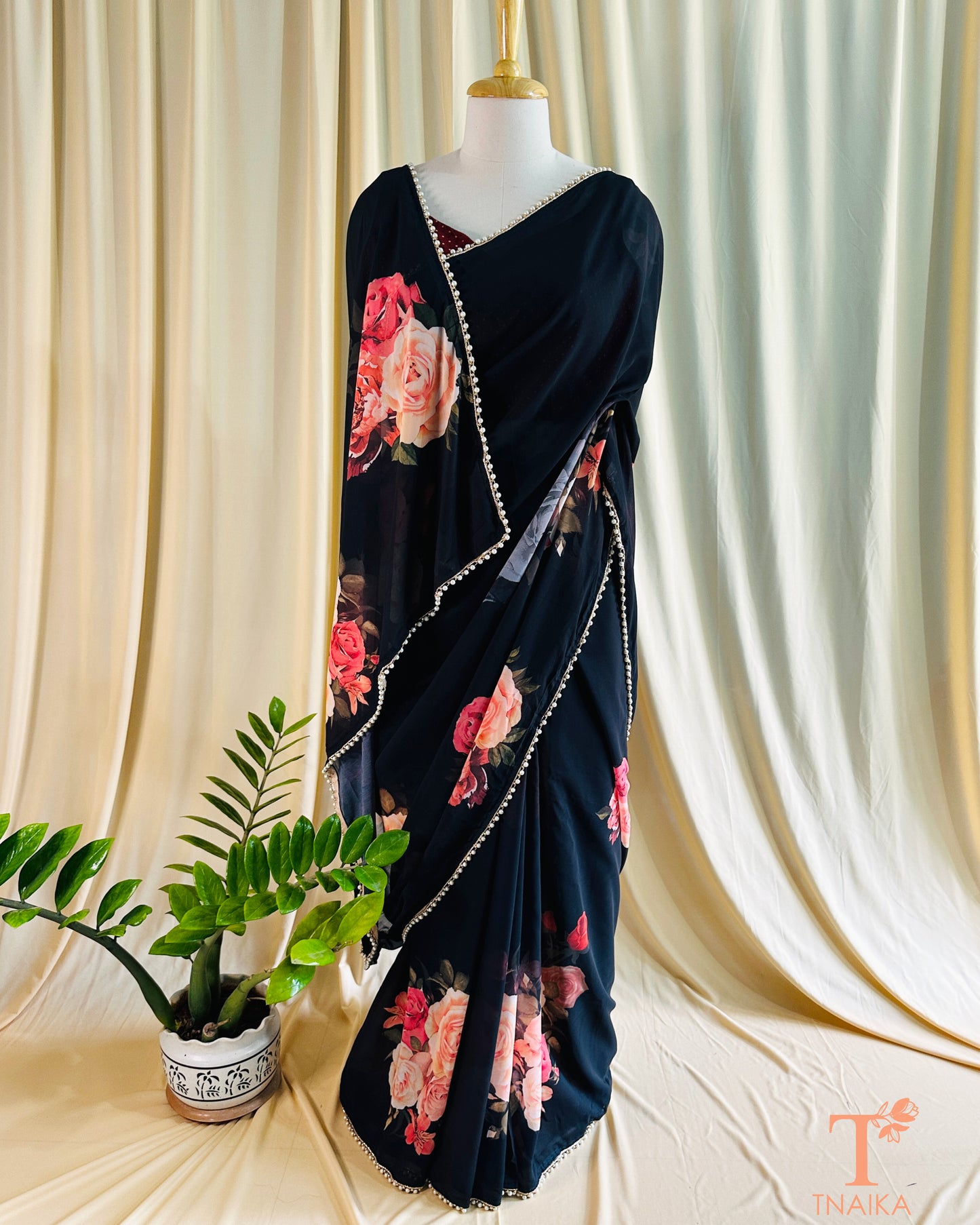Flowy floral georgette saree paired with a coordinated floral blouse.