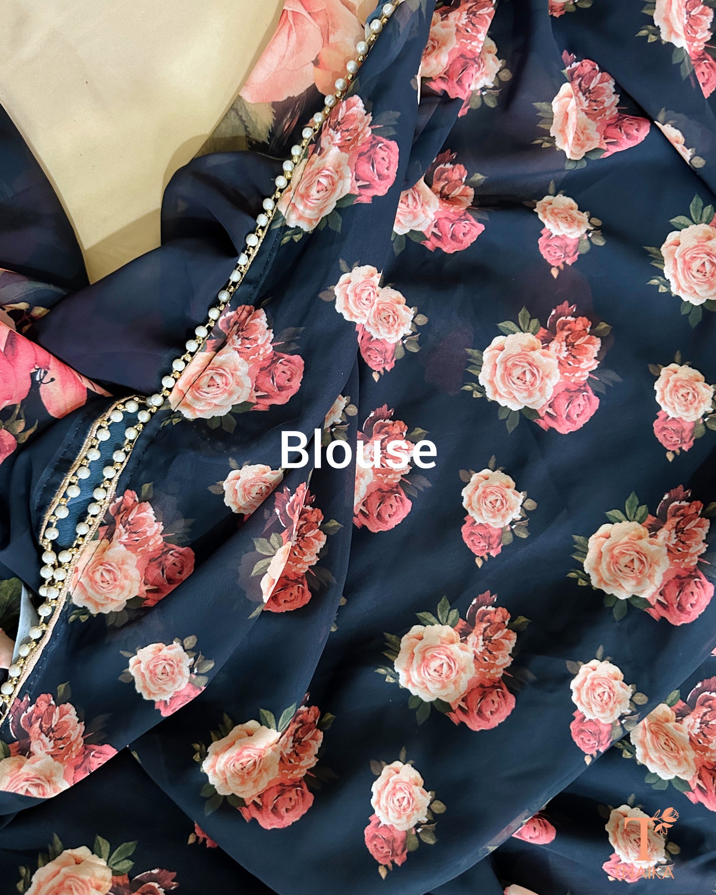Festive floral georgette saree with pearl lace border, perfect for parties and gatherings.