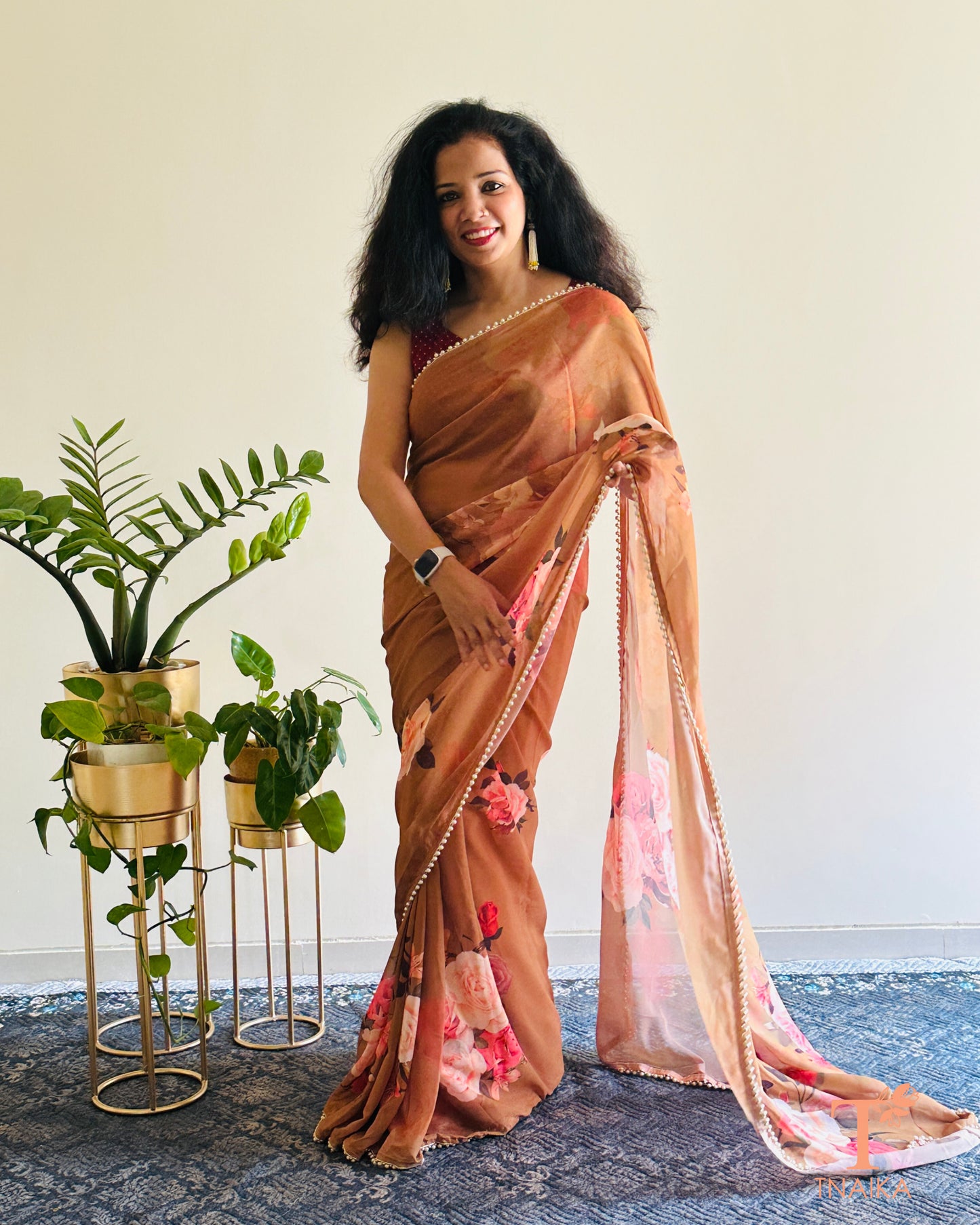 Lightweight floral georgette saree featuring pearl lace detailing for festive wear.