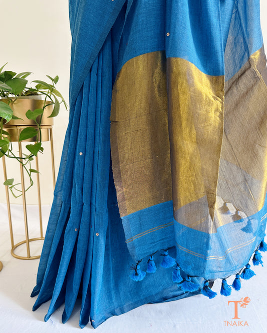 Festive cotton saree with shimmer foil tikki design and heavy tassels.