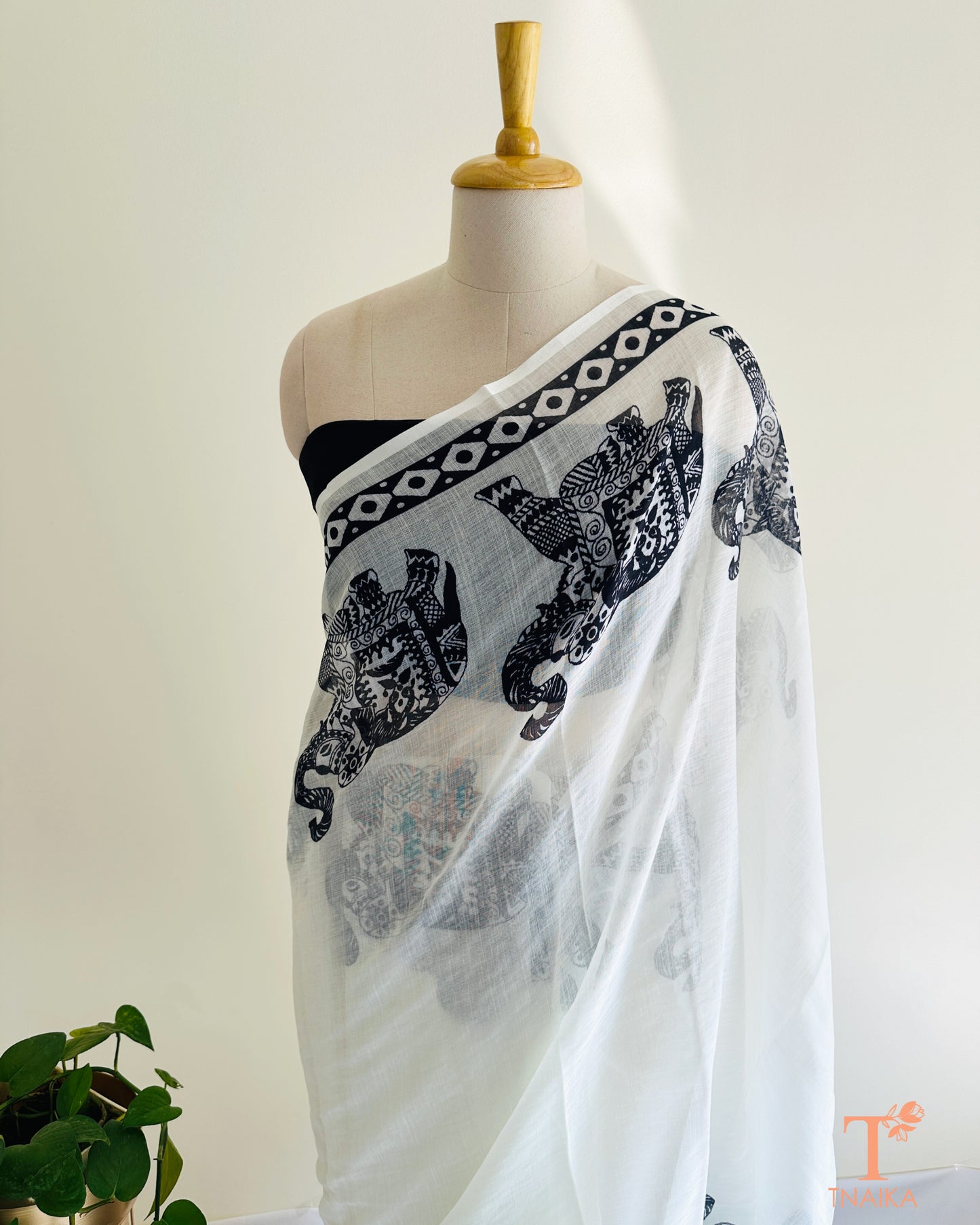 Minimal white saree with bold black elephant design