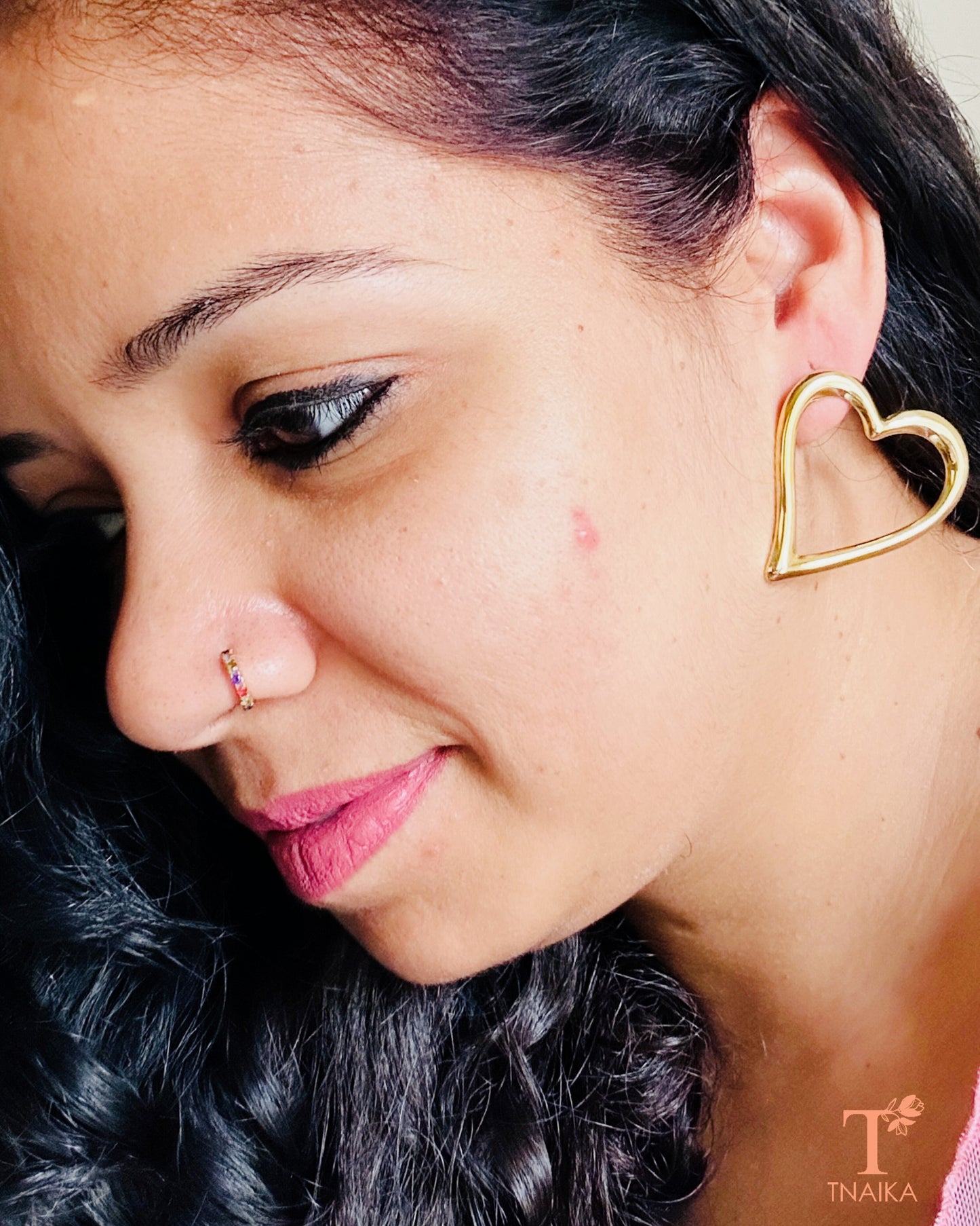 Gold heart shaped anti-tarnish stud earrings with glossy finish for daily wear and gifting.