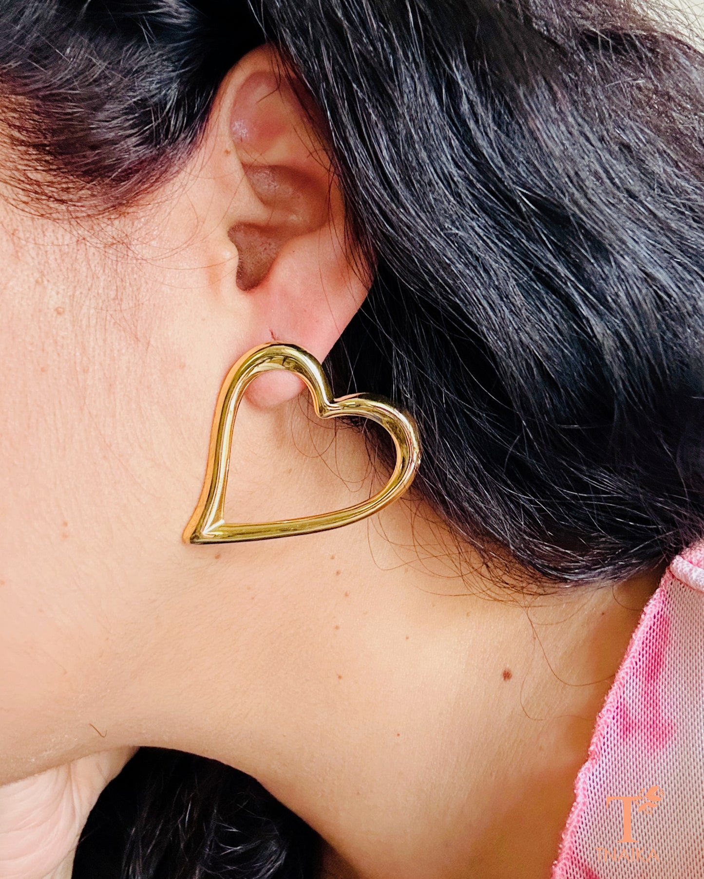 Gold heart shaped anti-tarnish stud earrings with glossy finish for daily wear and gifting.