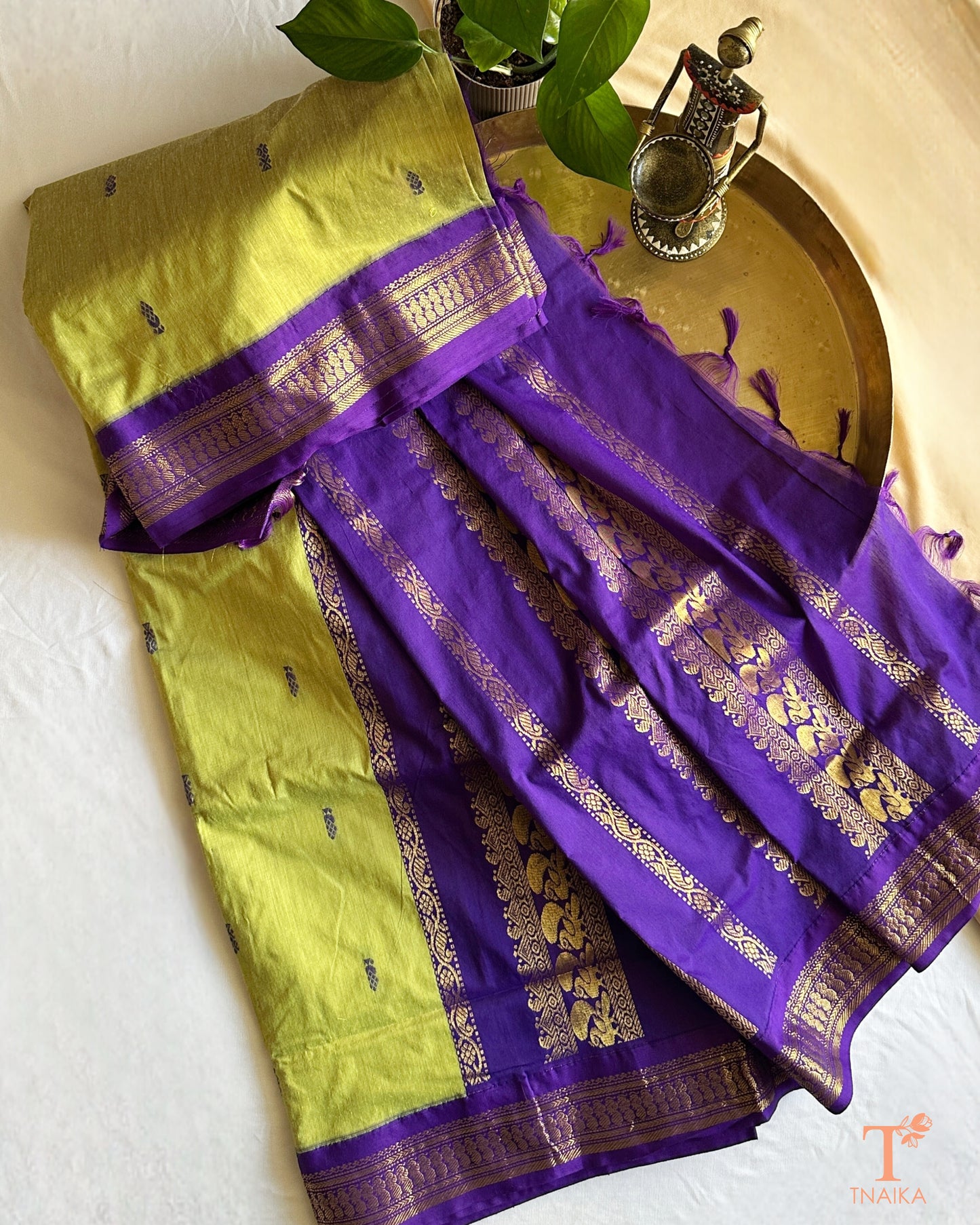 Soft cotton saree featuring traditional woven border and tassels