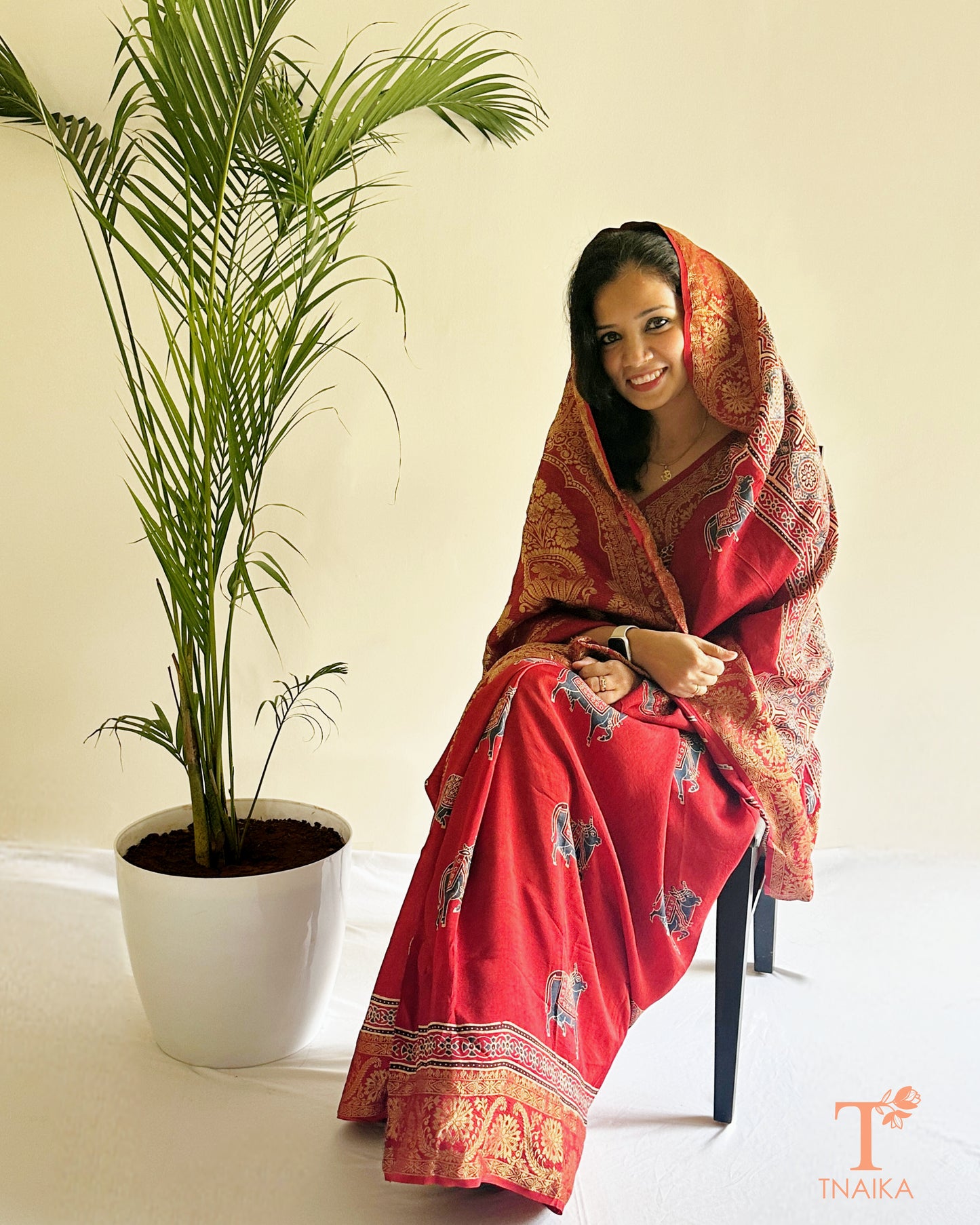 Red ethnic saree with heavy border and classic woven design
