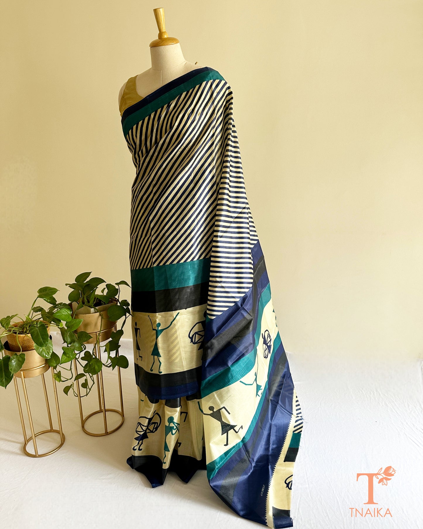 Artistic printed satin silk saree in navy, teal, and ivory tones with statement ethnic design
