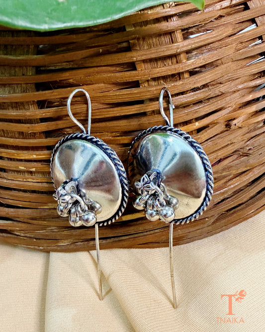 Traditional oxidised ear wrap earrings with circular shield motif.