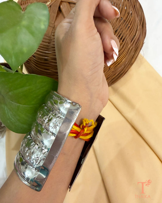 Broad oxidised metal hand cuff with hammered detailing, designed for festive, boho, and Indo-western looks.