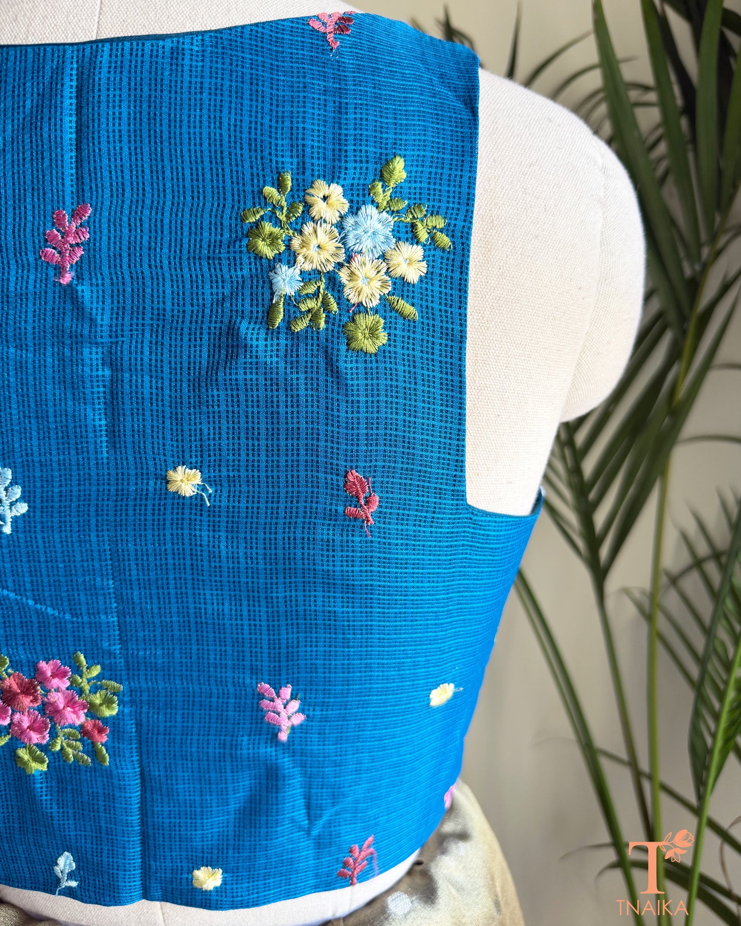 Close-up of floral embroidery detailing on premium Kota silk blouse showcasing handcrafted artistry.
