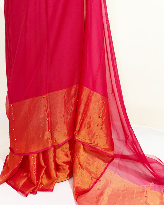 Lightweight chiffon saree featuring pearl embellished gold border.