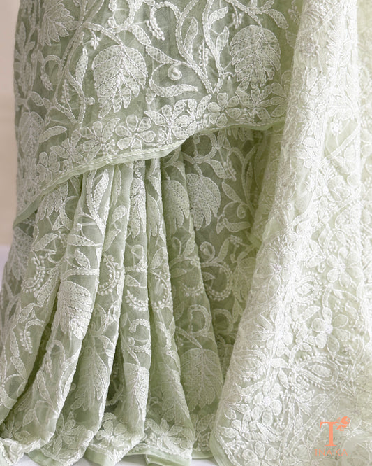 Elegant mint green Chikankari saree featuring handcrafted white floral embroidery and richly embroidered pallu.