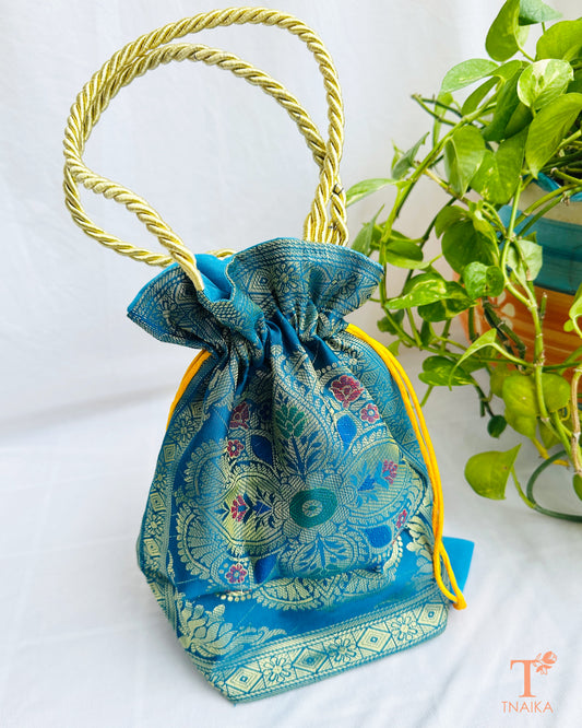 Traditional Banarasi woven fabric convertible handbag featuring dual styling as a tote bag or drawstring potli with rope handles.