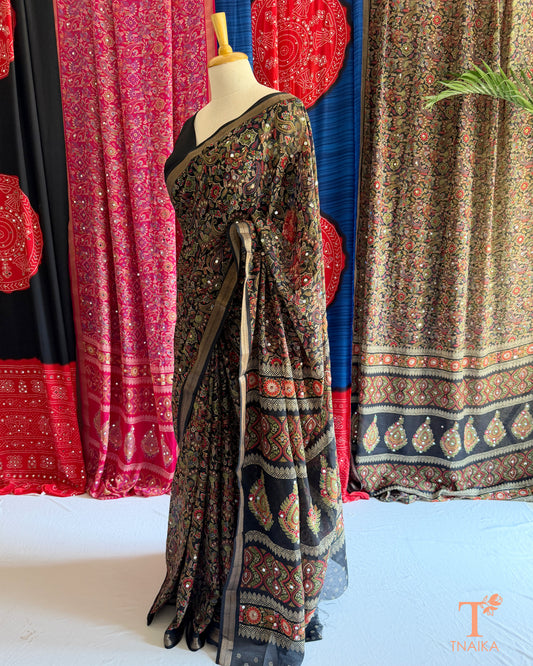 Black festive saree with detailed border and traditional printed design