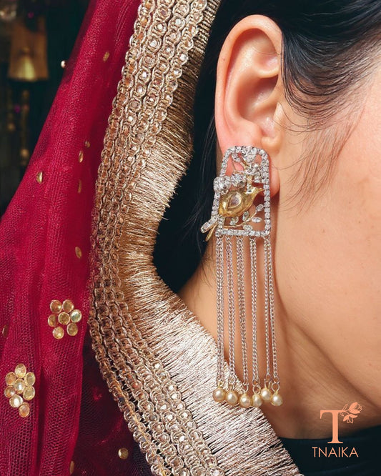 Dual tone silver replica earrings with bird stud and chain hanging design.