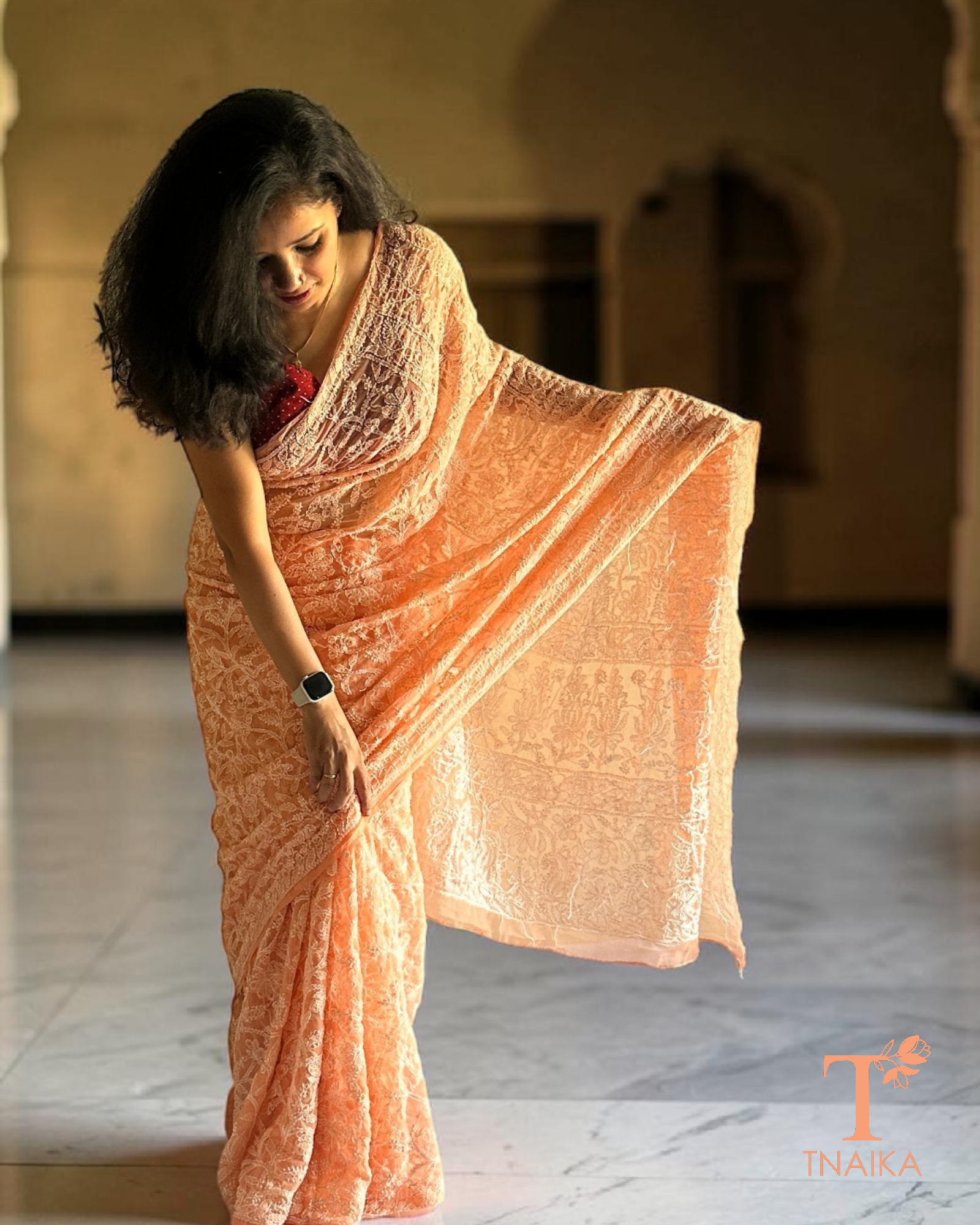 Elegant georgette saree with all-over chikankari work in pastel peach shade