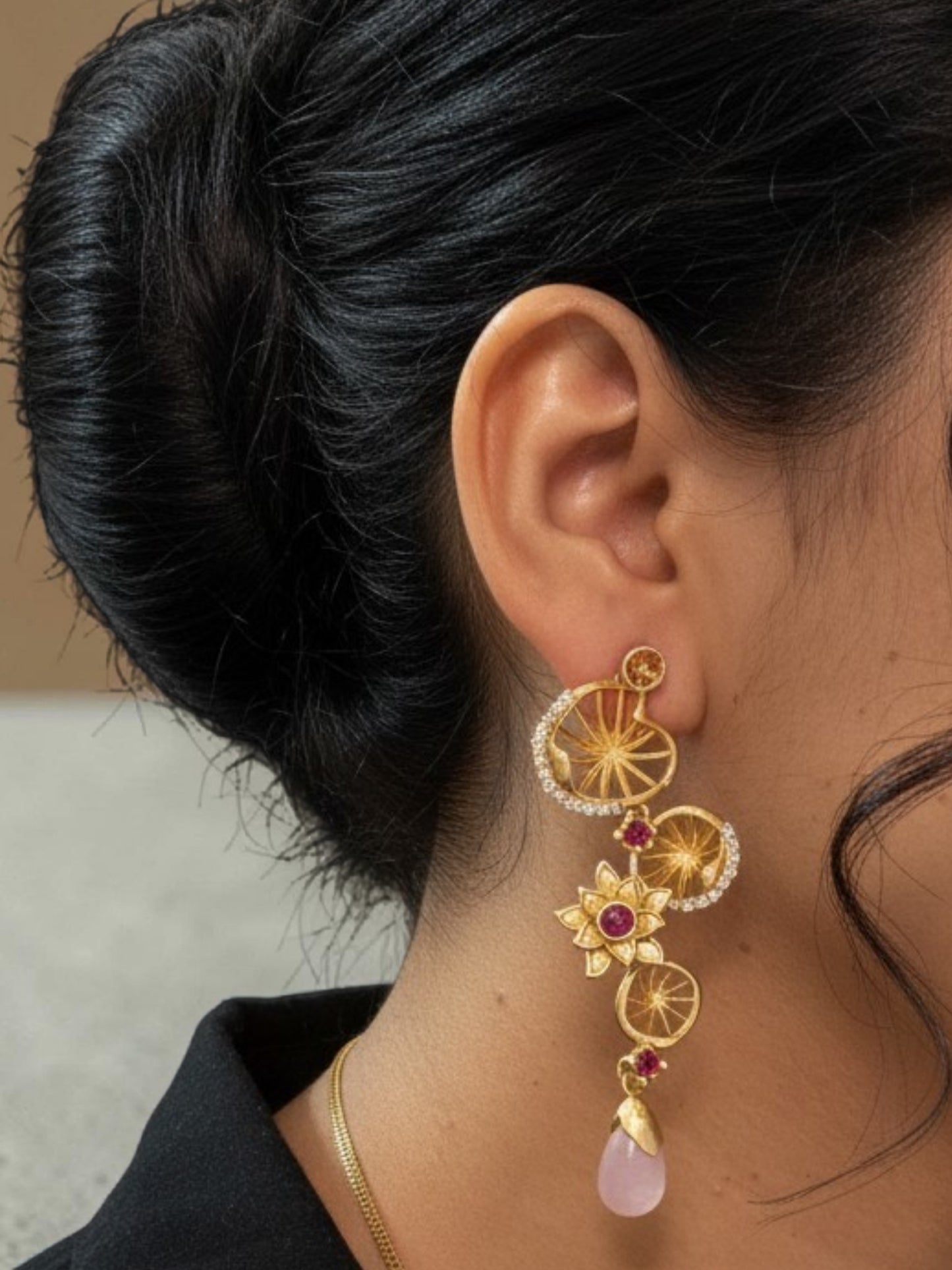 Designer floral matte gold earrings with ruby stones, zircon embellishments and pink teardrop bead accents.