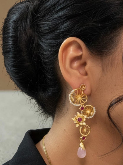 Designer floral matte gold earrings with ruby stones, zircon embellishments and pink teardrop bead accents.