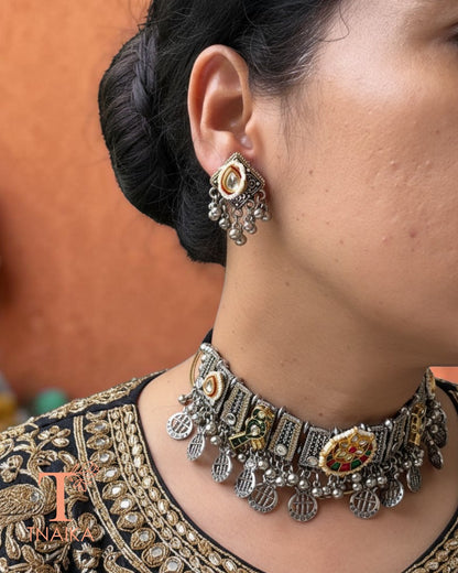 Woman wearing Rajsi Kundan Virasat oxidised choker featuring kundan floral centerpiece, bird motifs, pearl detailing, ghungroo and coin danglers.