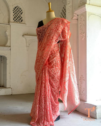 Coral pink saree featuring traditional white Chikankari embroidery