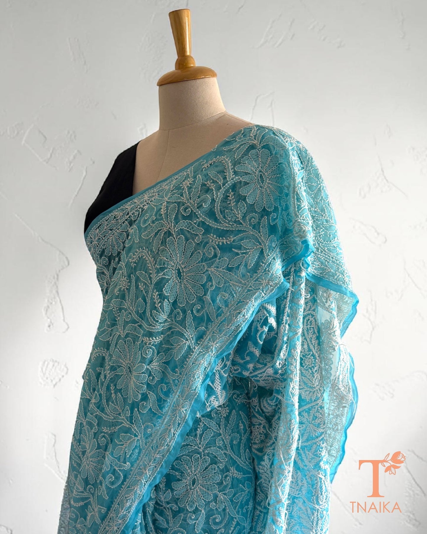 Elegant blue Chikankari saree with floral and paisley motifs