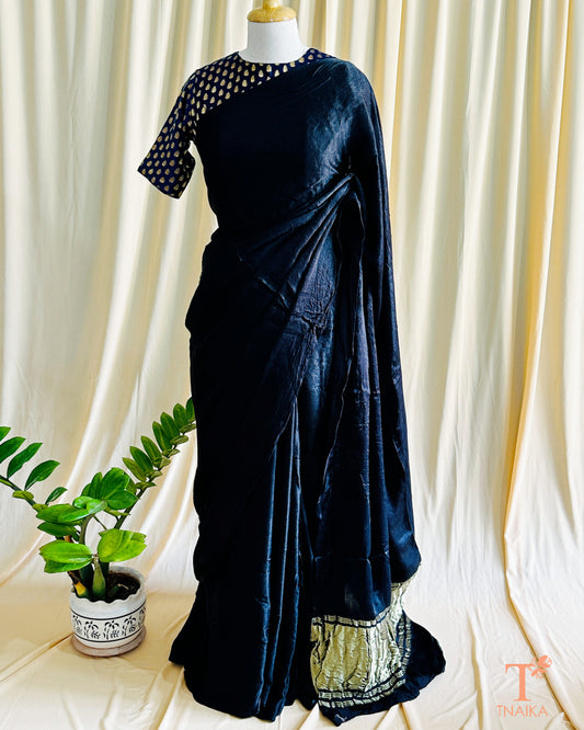 Plain black modal silk saree with smooth texture and elegant drape
