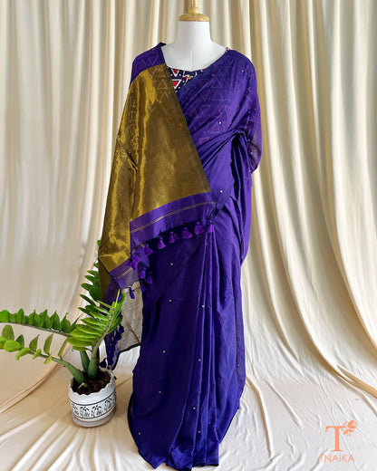 Festive cotton saree featuring subtle shimmer and heavy tassel details