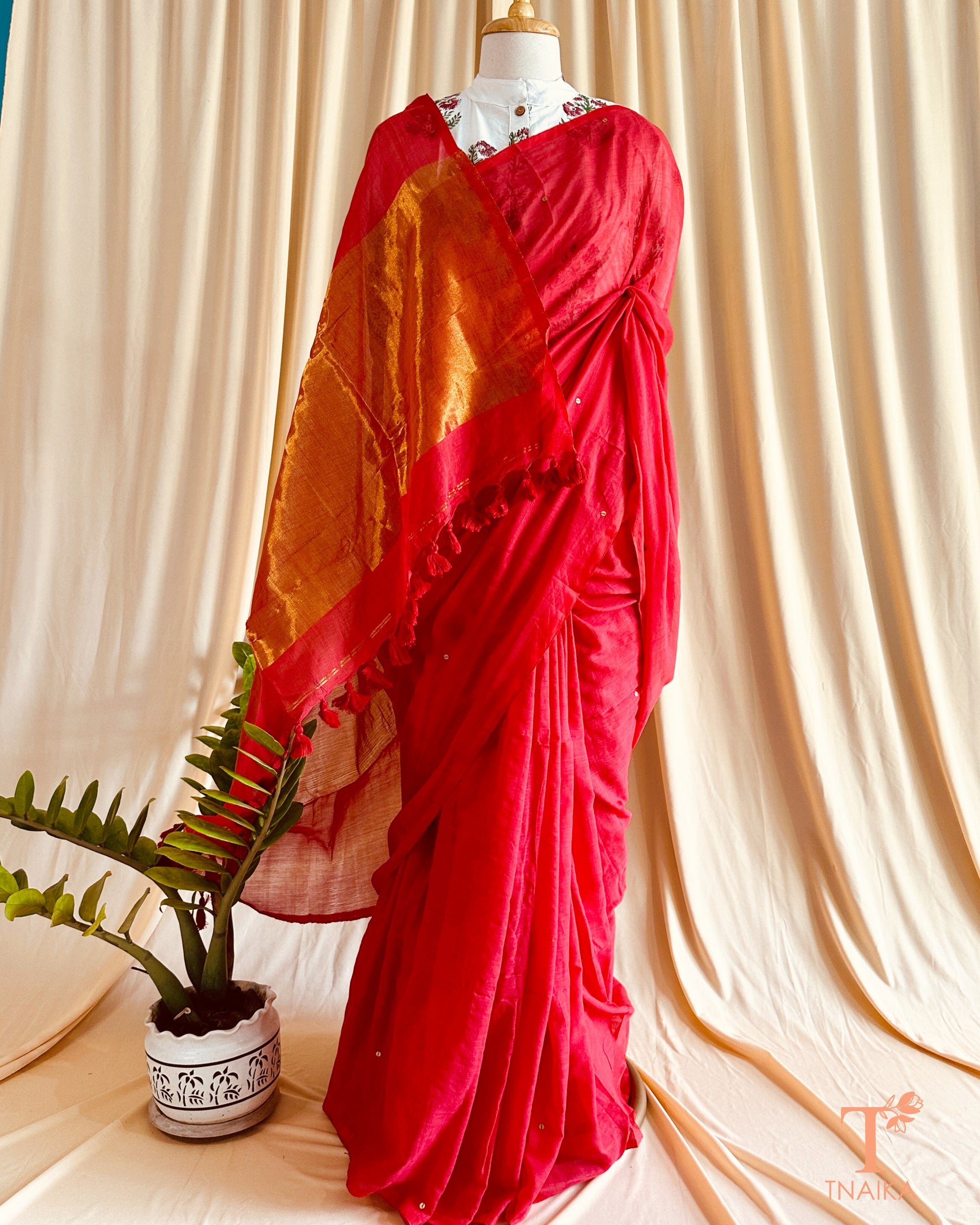 Traditional cotton saree in black with broad brown border styled with contrasting blouse