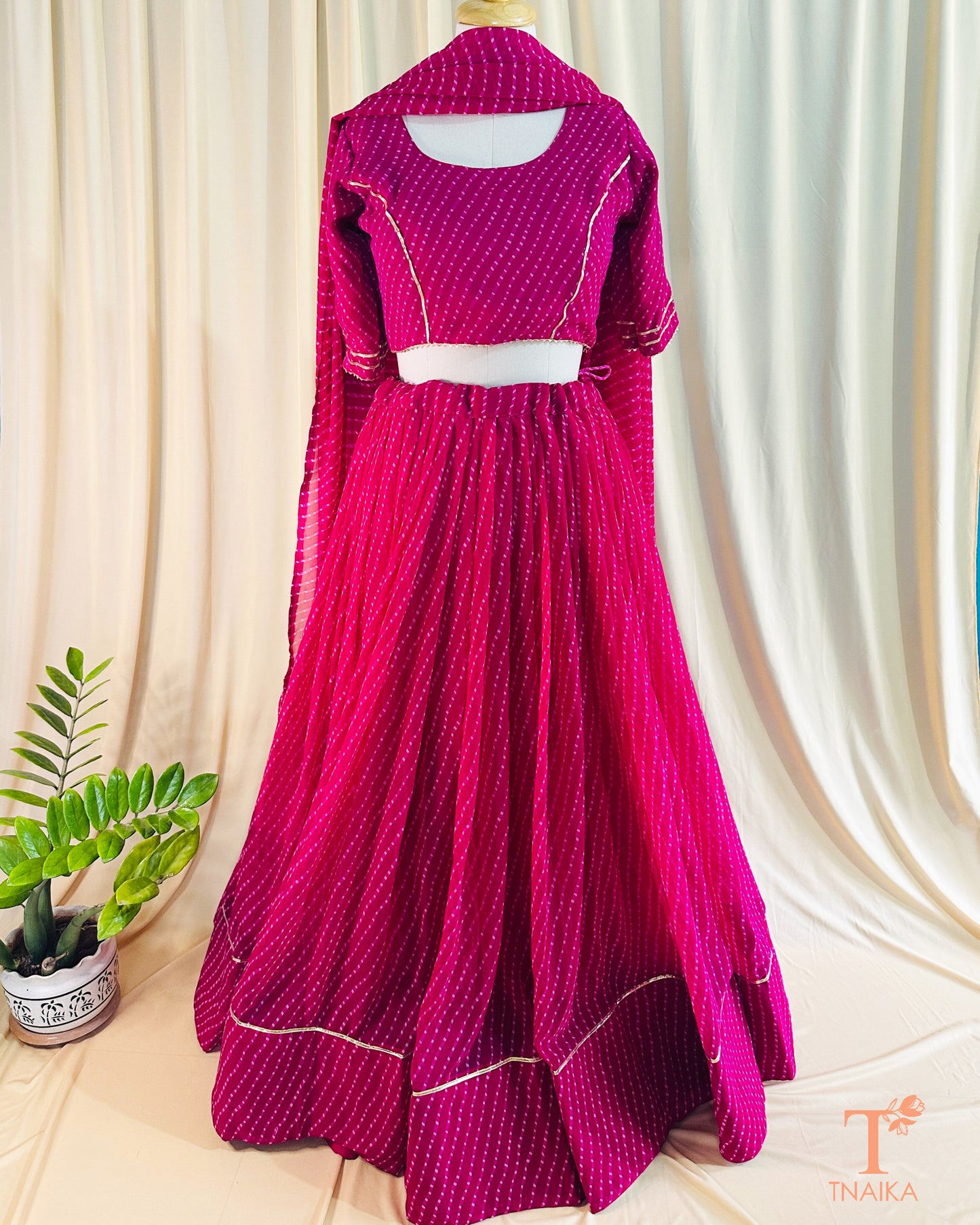 Vibrant Leheriya georgette lehenga featuring lace detailing, ideal for weddings and festive occasions