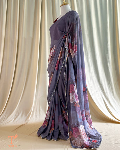 Flowy floral georgette saree paired with a coordinated floral blouse.