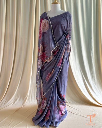 Soft georgette saree with floral prints and elegant pearl lace finish.