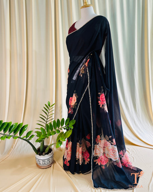 Soft georgette saree with floral prints and elegant pearl lace finish.