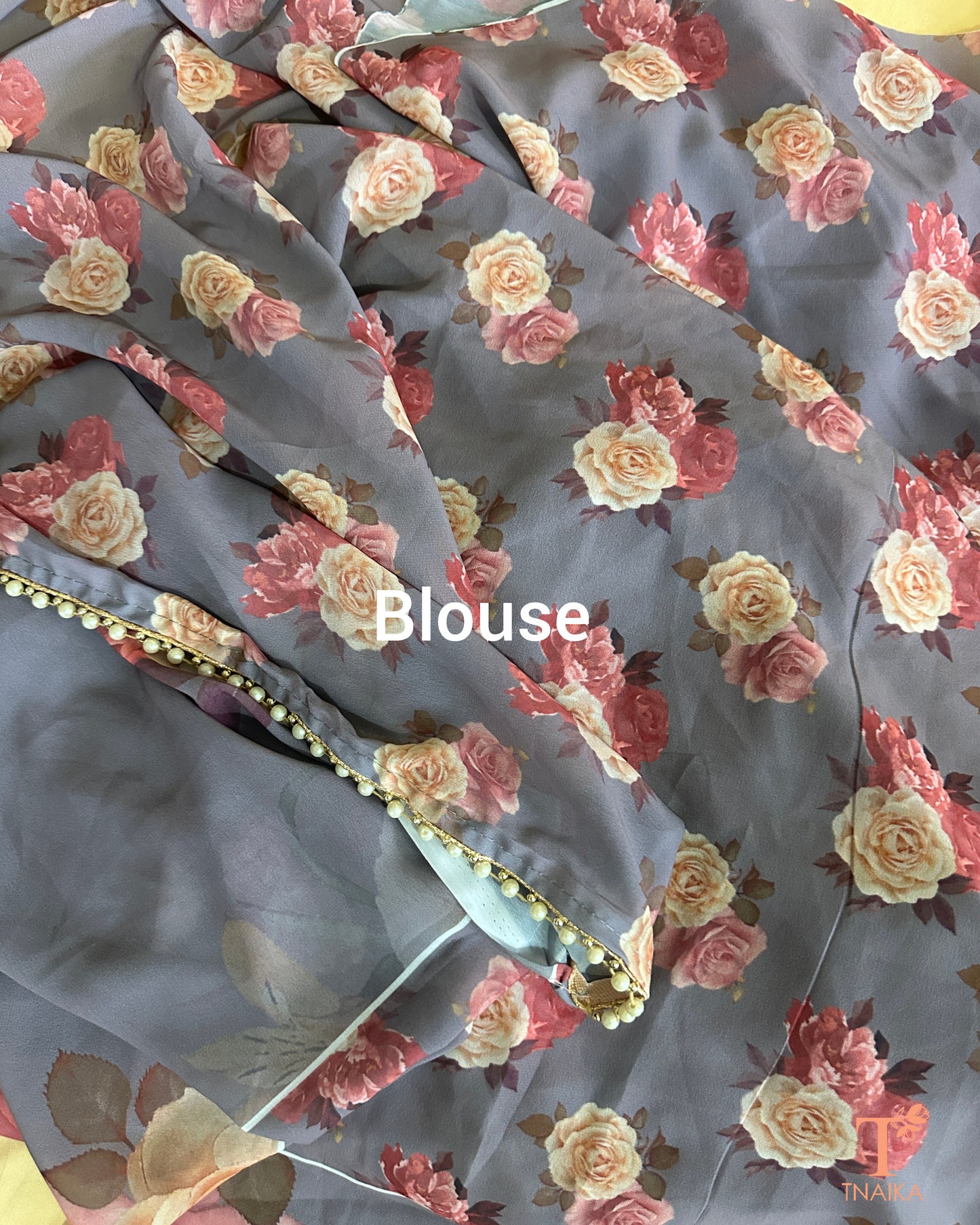 Lightweight floral georgette saree featuring pearl lace detailing for festive wear.