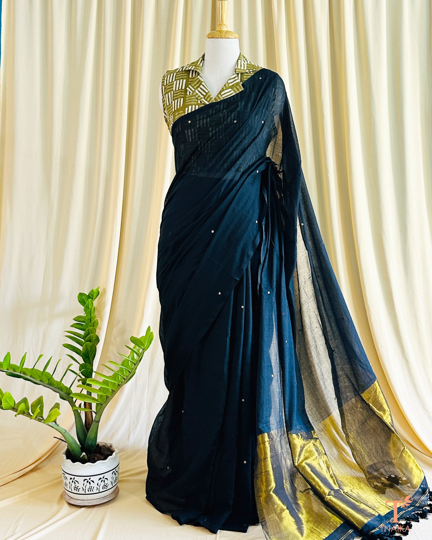 Cotton saree with delicate foil tikki work and golden tissue pallu.