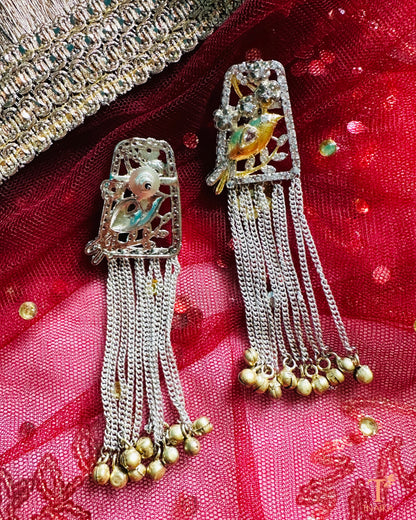 Silver chain drop earrings with handcrafted bird figure detailing.