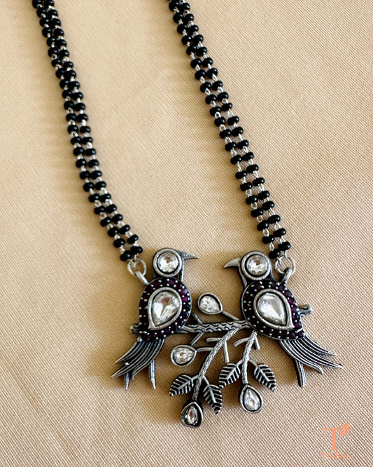 Oxidised silver-tone mangalsutra featuring a bird motif pendant with stone detailing