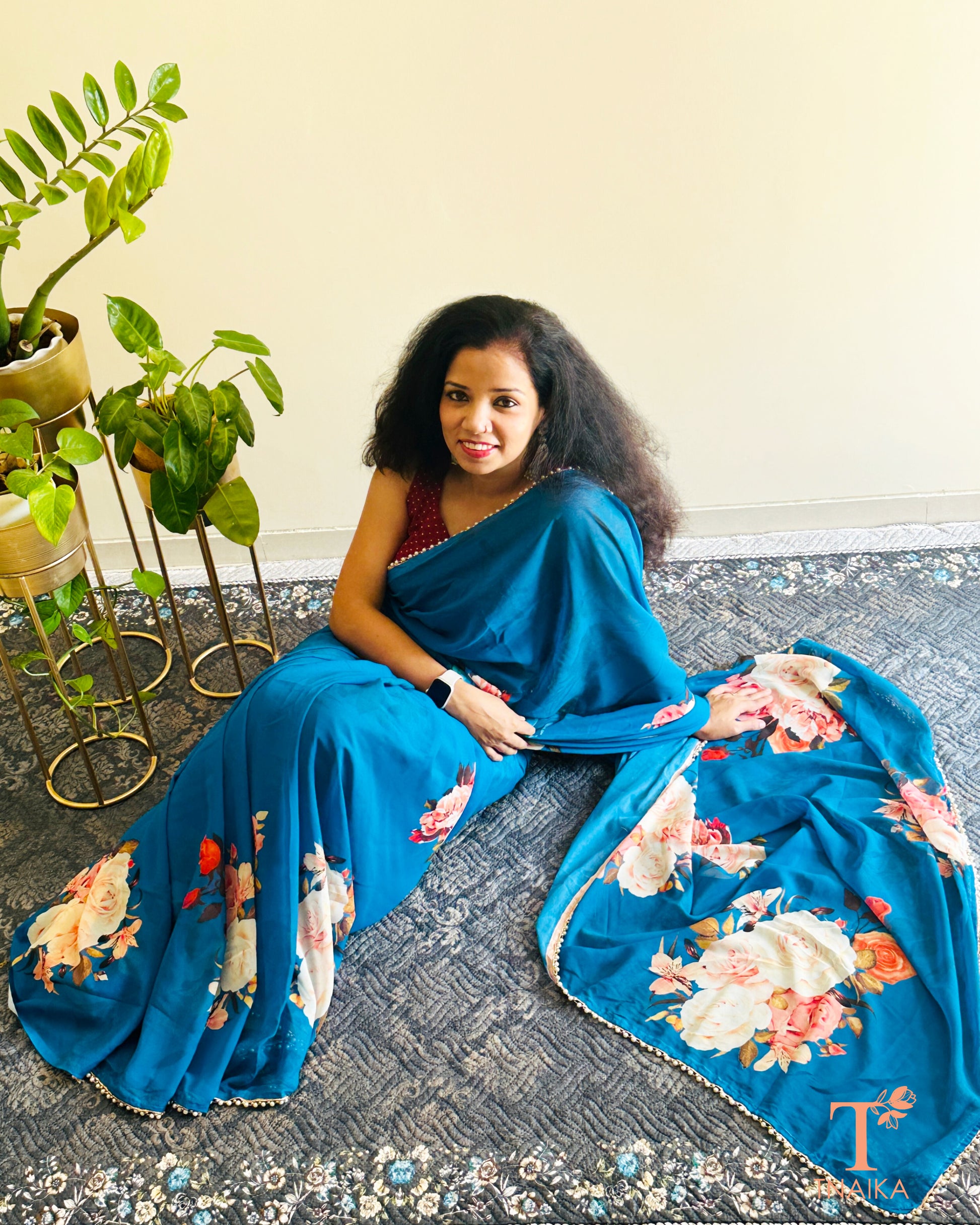 Festive floral georgette saree with pearl lace border, perfect for parties and gatherings.