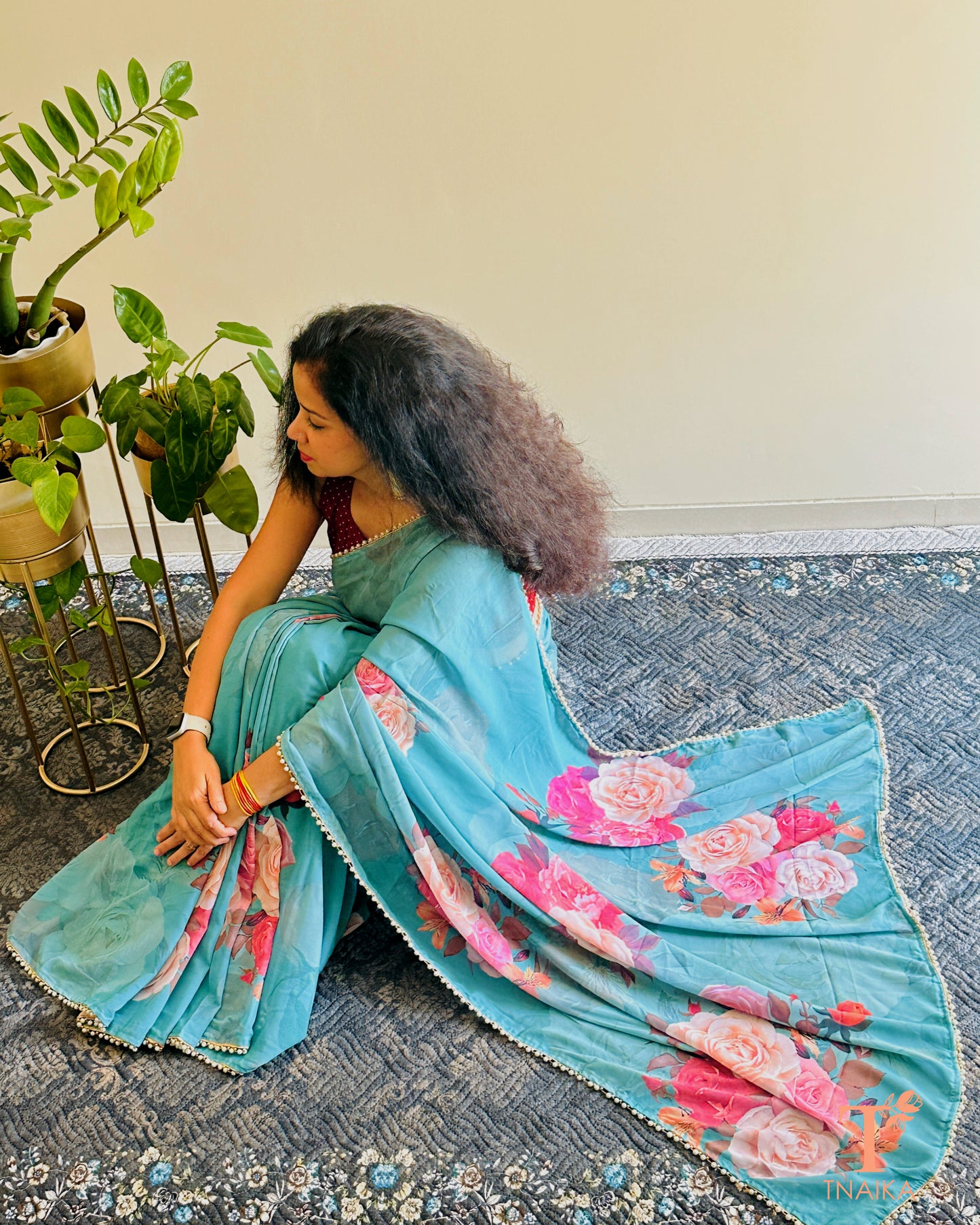 Festive floral georgette saree with pearl lace border, perfect for parties and gatherings.