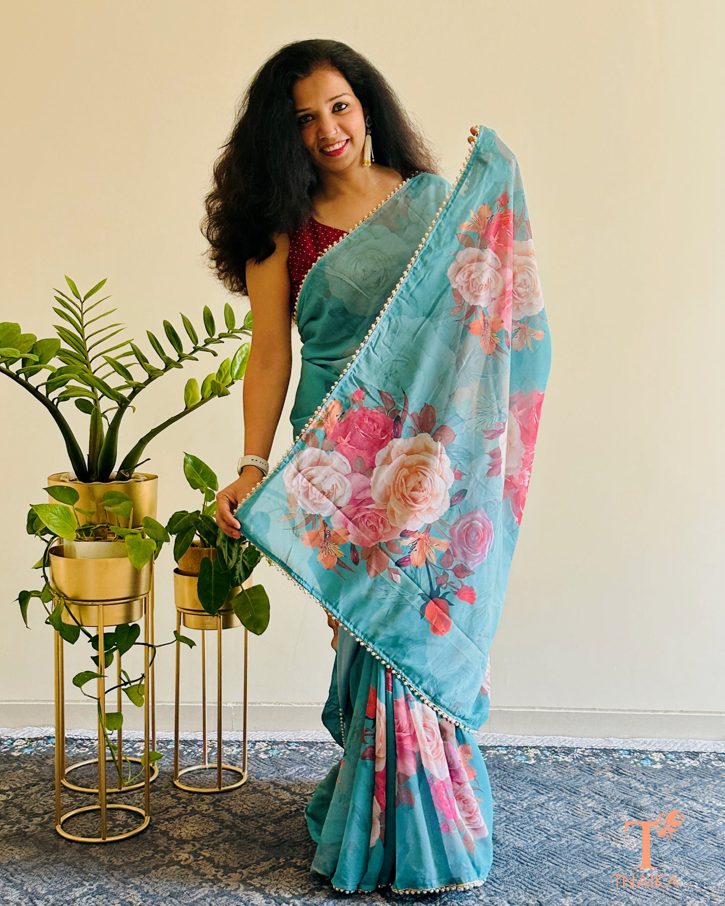 Soft georgette saree with floral prints and elegant pearl lace finish.