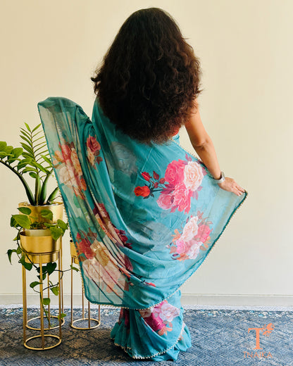 Flowy floral georgette saree paired with a coordinated floral blouse.