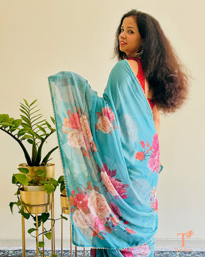 Lightweight floral georgette saree featuring pearl lace detailing for festive wear.