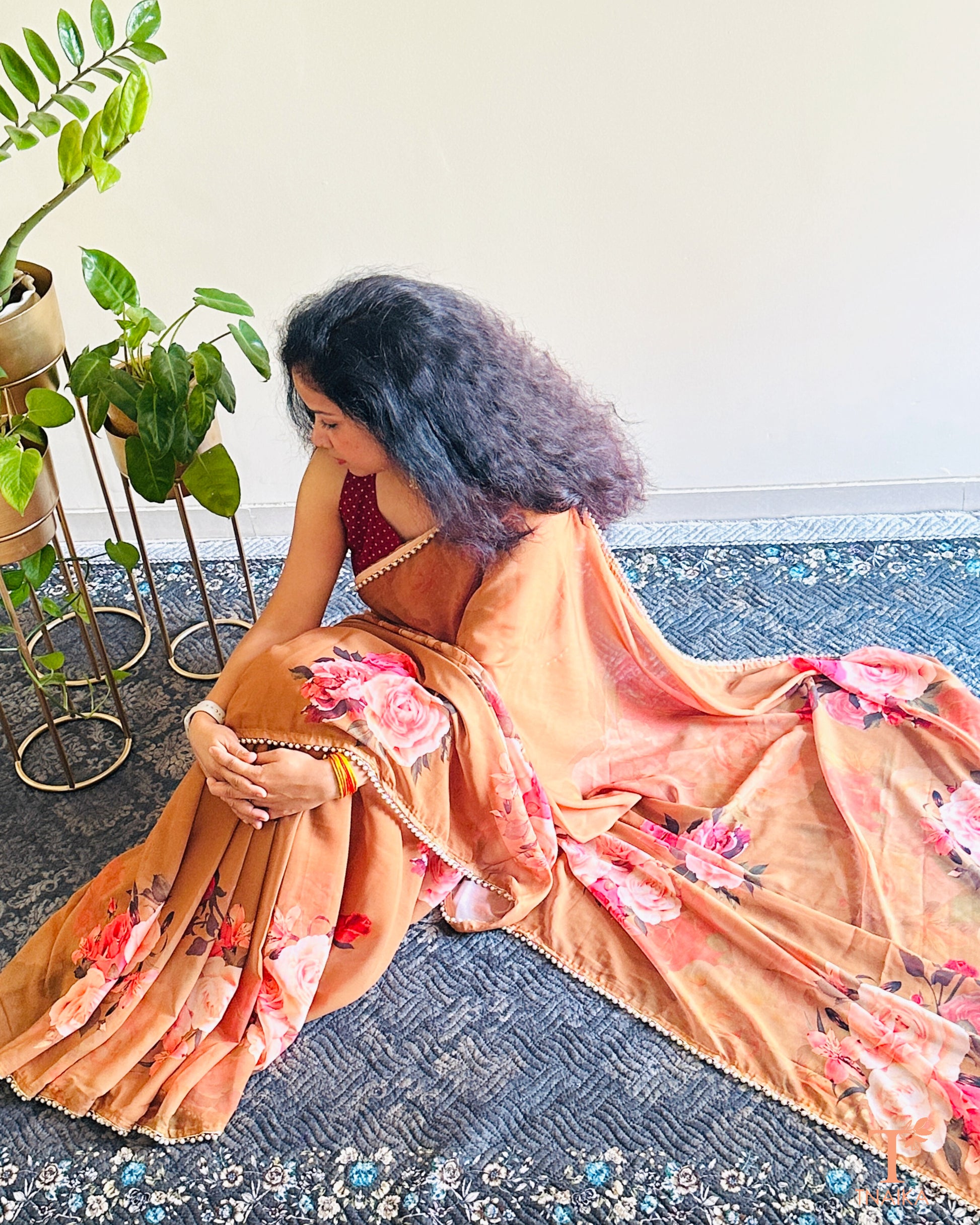 Lightweight floral georgette saree featuring pearl lace detailing for festive wear.