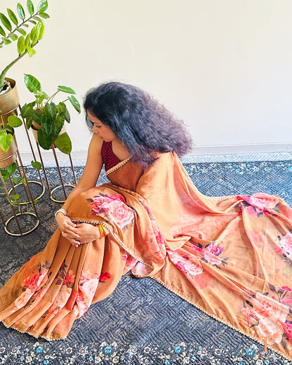 Lightweight floral georgette saree featuring pearl lace detailing for festive wear.