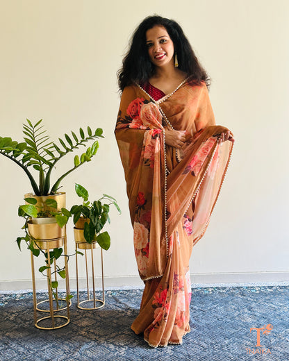 Flowy floral georgette saree paired with a coordinated floral blouse.