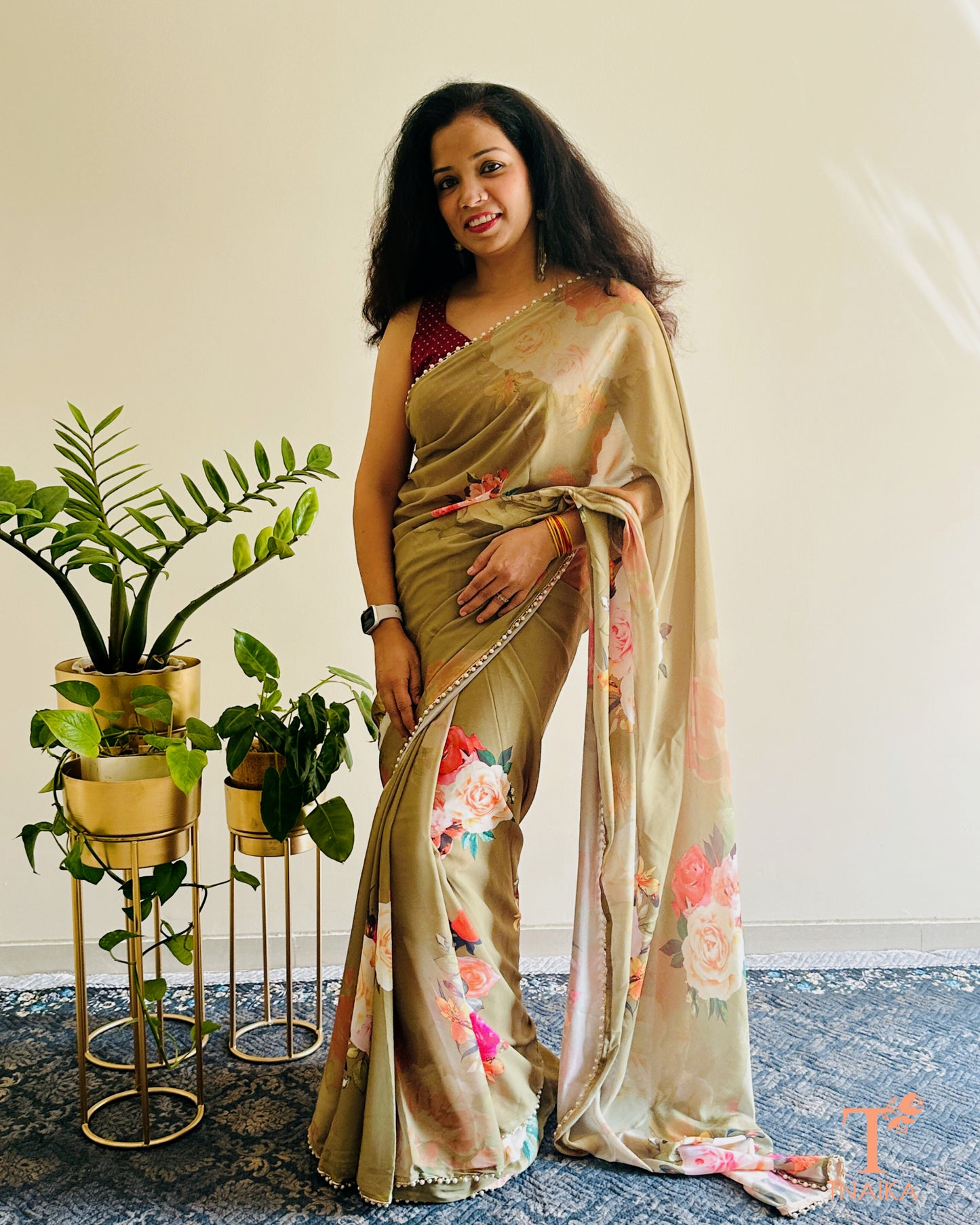 Festive floral georgette saree with pearl lace border, perfect for parties and gatherings.